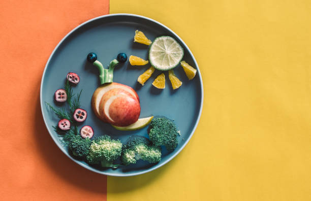 istock healthy breakfast for children, creative ideas from fruit and vegetables, vitamins on plate, copy space 1329562102