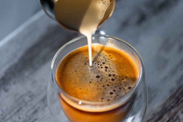 istock Milk is poured into a cup of coffee. Morning invigorating coffee 1329562656