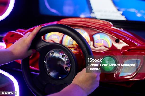 Woman Playing In The Game Room Stock Photo - Download Image Now - Car, Simulator, Arcade