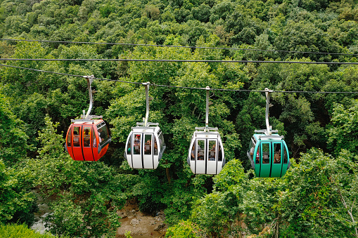 The cable cars to Jeita Grotto surrounded by greenery under the sunlight at Lebanon. Travel concept