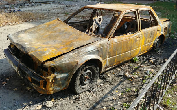 istock burned car sedan after street riots 1329564290