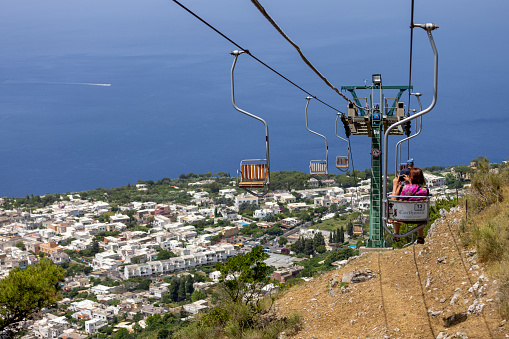 Capri Island, Italy - June 28, 2021: Chairlift to Monte Solaro, view of the high chairs with tourists