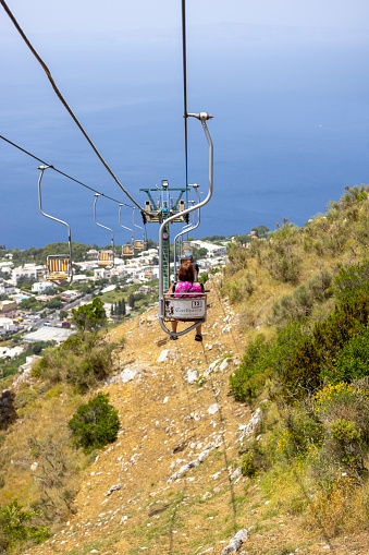 Capri Island, Italy - June 28, 2021: Chairlift to Monte Solaro, view of the high chairs with tourists