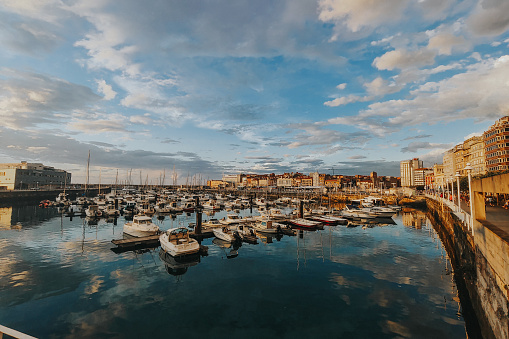 A beautiful view of Gijon Port, in Asturias, Spain with building and sky reflections on the water. Vacation places concept