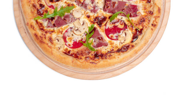 istock Delicious pizza served on wooden plate isolated on white 1329565336