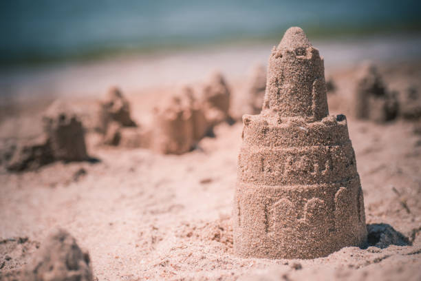 istock Sand castle standing on the beach. Travel vacations concept 1329566567