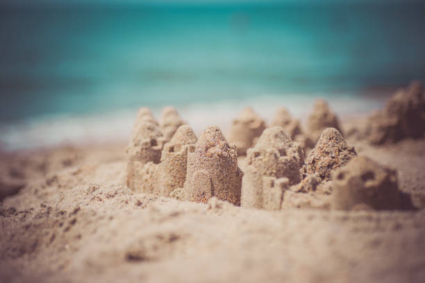 istock Sand castle standing on the beach. Travel vacations concept 1329566573