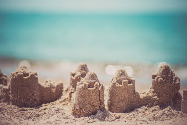 istock Sand castle standing on the beach. Travel vacations concept 1329566575