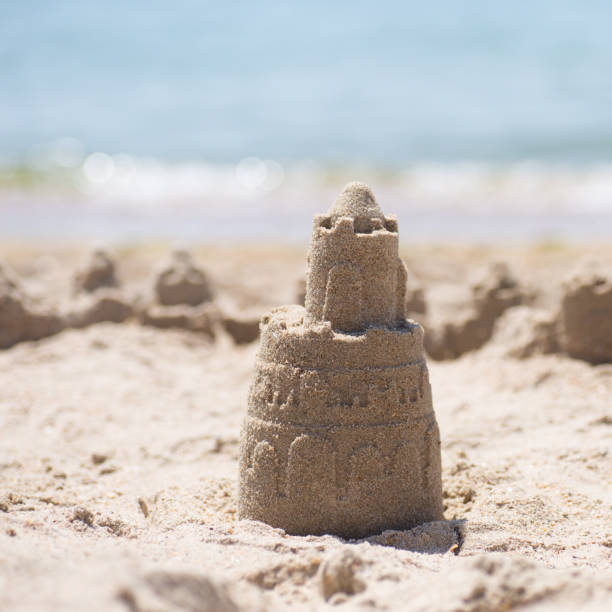 istock Sand castle standing on the beach. Travel vacations concept 1329566577
