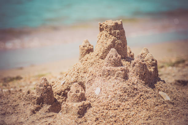 istock Sand castle standing on the beach. Travel vacations concept 1329566614