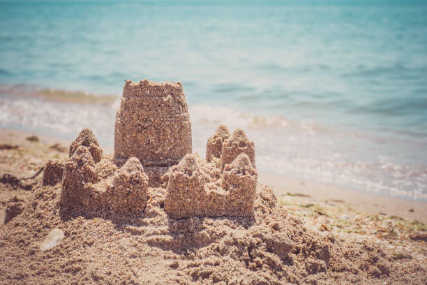 istock Sand castle standing on the beach. Travel vacations concept 1329566622