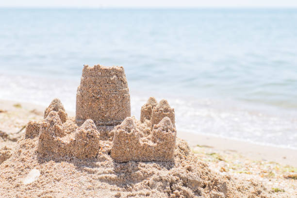 istock Sand castle standing on the beach. Travel vacations concept 1329566623