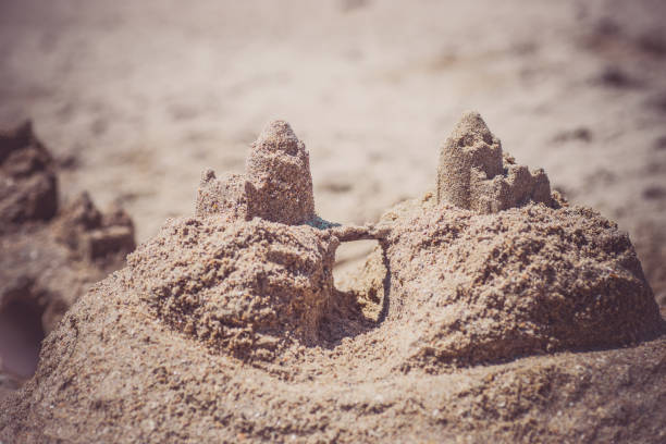 istock Sand castle standing on the beach. Travel vacations concept 1329566633