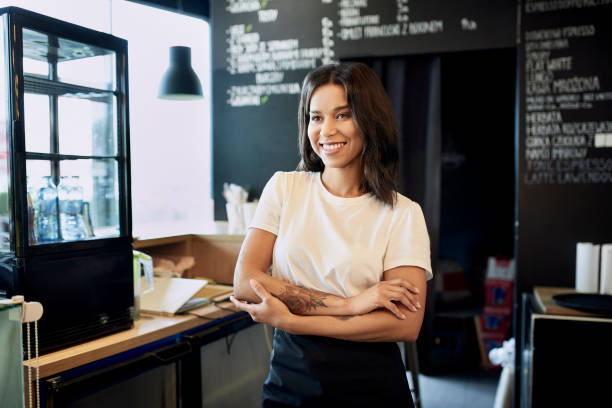 istock Smiling cafe, bar owner standing with crossed arms 1329568957