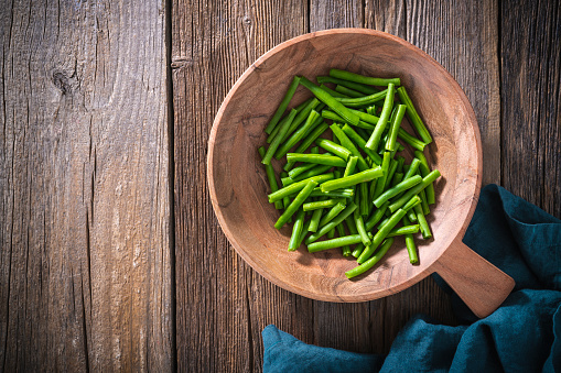 Green beans cut on rustic wood table background