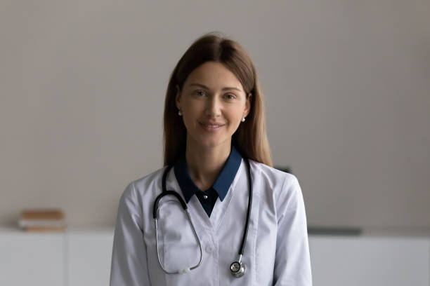 istock Happy young female doctor looking at camera 1329569957