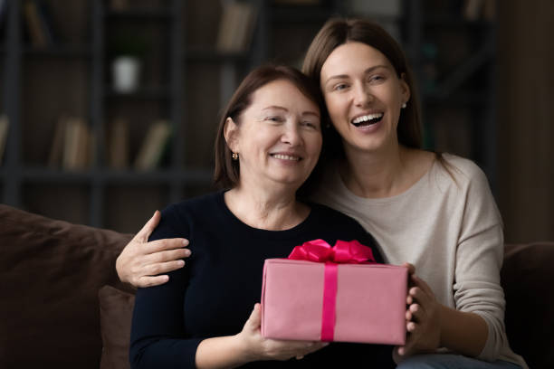 happy grateful grownup daughter and senior mom celebrating mothers day - mother gift imagens e fotografias de stock