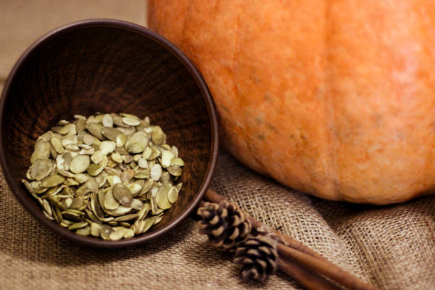 istock Autumn mood. Large yellow pumpkin on burlap 1329571826