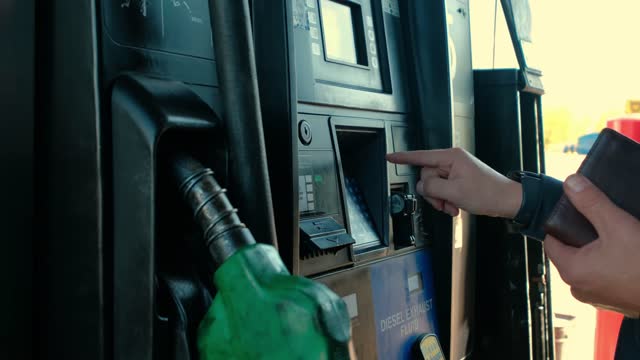 Close up futage of Filling up a car with fuel at truck gas station, Slow motion shot