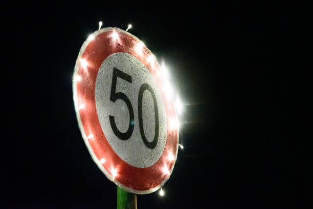50th birthday: side view of a frozen illuminated traffic sign with number 50