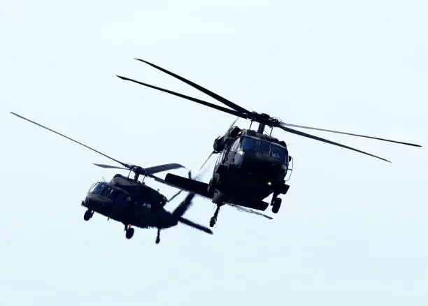 U.S. Army Blackhawk UH-60 helicopters fly over Arlington, Virginia.