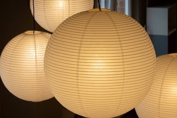 istock Large, white paper lamps illuminate the room 1329575029
