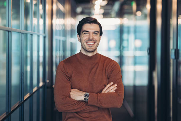 istock Cheerful man standing with crossed arms 1329575925