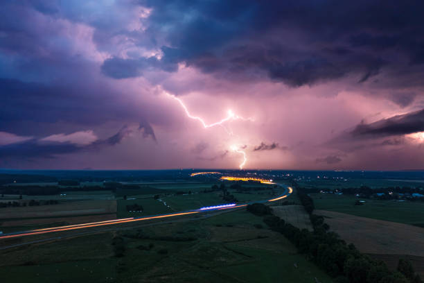 istock Heavy storm over express road and fields, dark clouds and lightning in the evening 1329576133