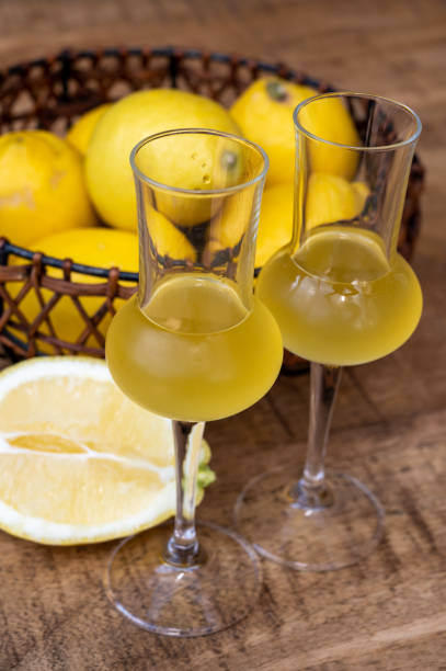 Glasses of cold sweet italian strong alcoholic liquor limoncello made from fresh lemons. Glasses of cold sweet italian strong alcoholic liquor limoncello made from fresh lemons close up amalfi food stock pictures, royalty-free photos & images