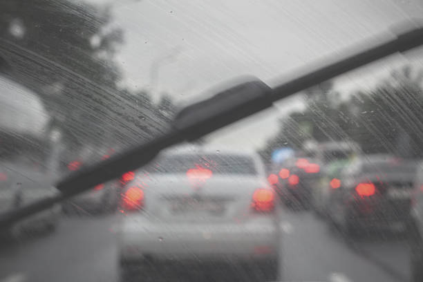istock Traffic jam on a rainy day. Inside view of a car through a windshield. Raindrops on the window 1329578750