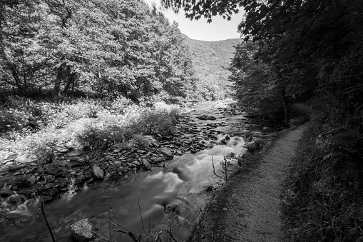 Black and white photo of the East Lyn river flowing through the Doone Valley at Watersmmeet in Devon