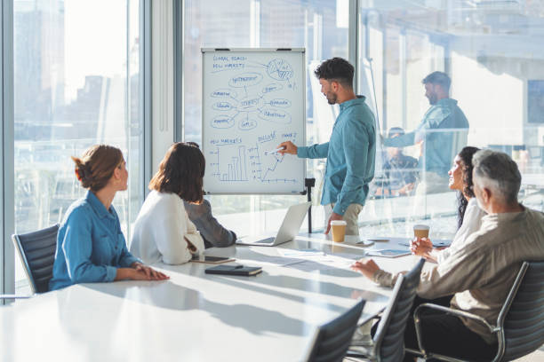 istock Business people watching a presentation on the whiteboard. 1329584655