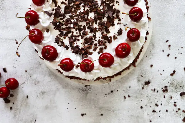 Stock photo showing an elevated view of a homemade, luxury, Black Forest gateau displayed against a marble effect background.