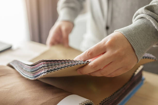 istock female designer with fabric color samples choosing textile for curtains 1329596743