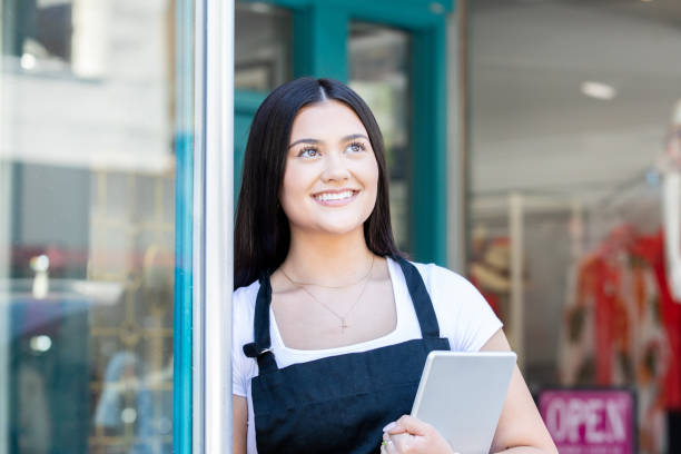 istock Boutique employee smiles while opening store for the day 1329596959