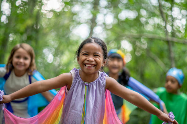 istock Kids playing in the forest with colorful silks 1329597243