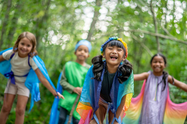 istock Kids playing in the forest with colorful silks 1329597245