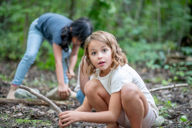 istock Child enjoying nature play, learning wilderness skills 1329597249