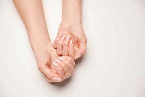 istock Woman hands with beautiful manicure on light background 1329597685