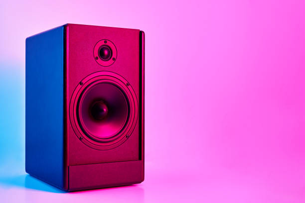 istock Stereo sound speaker on neon colored background 1329602295