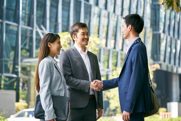 istock asian business people shaking hands on street 1329603099