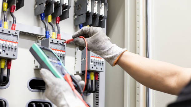 istock Electrician engineer work tester measuring voltage and current of power electric line in electical cabinet control. 1329604159