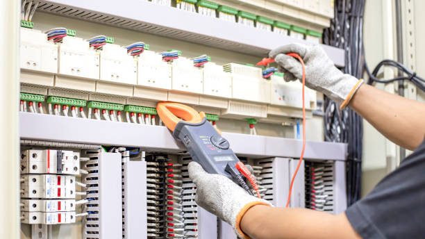 istock Electrician engineer work tester measuring voltage and current of power electric line in electical cabinet control. 1329604727