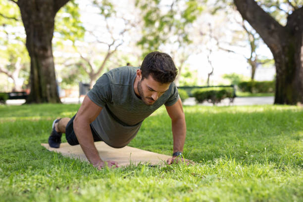 istock Young man exercising outdoors 1329605633