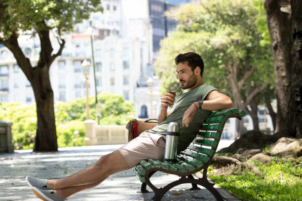 istock Young man drinking mate at Buenos Aires square 1329606331