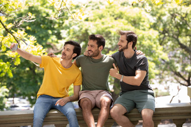 istock Three young men making self portraits and having fun at Buenos Aires 1329606347