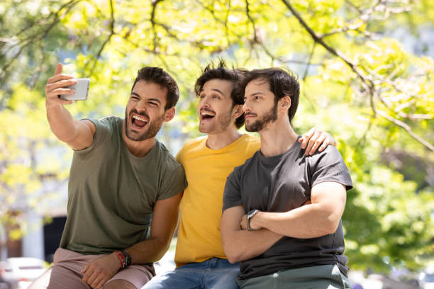 istock Three young men making self portraits and having fun at Buenos Aires 1329606495