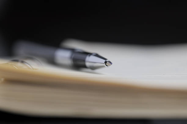 istock Close-up of pen on notebook 1329608189