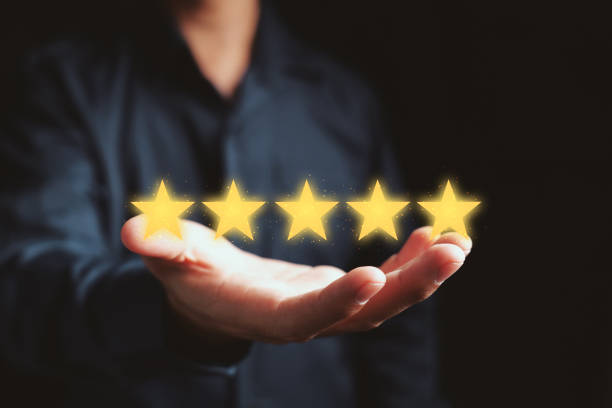 istock Customer satisfaction concept. hand holding the stars to complete five stars. giving a five star rating. Service rating concept. 1329608508