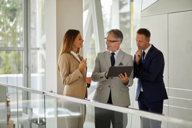 istock Group of mixed aged business people collaborating over digital tablet 1329608674